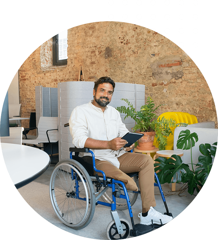 A man in a wheelchair with a tablet.